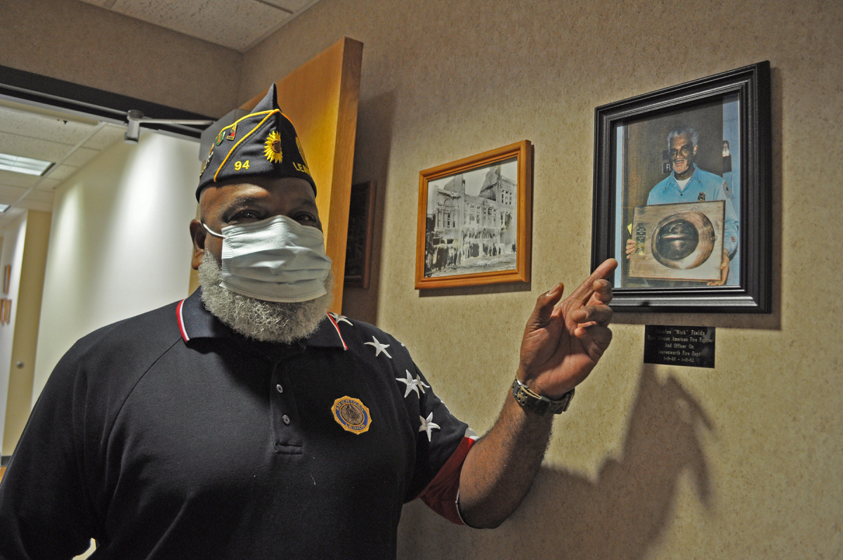 Rick Fields points out a photograph of his father, Charles Fields, First African American Firefighter in the city of Leavenworth