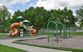 Playground equipment at David Brewer Park includes swings, slide