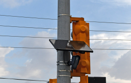 Photo shows a black panel mounted to a traffic safety light