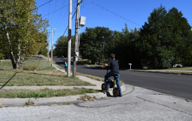 Child lifts bike over curb without ADA ramp