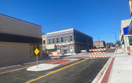 Street intersection snows three lanes with a median in the left turning lane of fourth street to prevent turning on the one-way