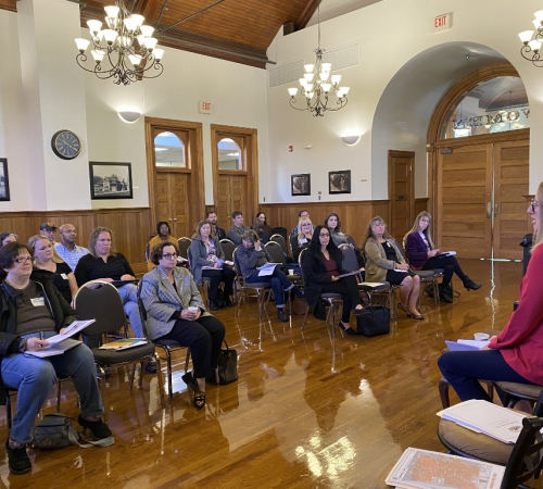 Penny Holler Assistant City Manager speaking to a crowd of business professionals at the Riverfront Community Center Oct. 17 