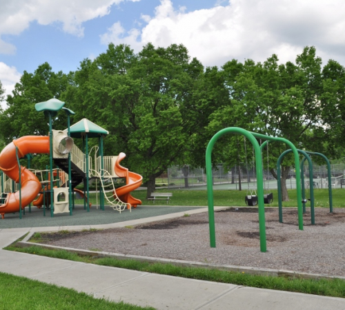 Playground equipment at David Brewer Park includes swings, slide