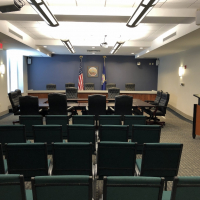 City Commission chambers, room with chairs and a Leavenworth logo