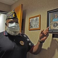 Rick Fields points out a photograph of his father, Charles Fields, First African American Firefighter in the city of Leavenworth