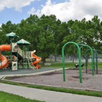 Playground equipment at David Brewer Park includes swings, slide