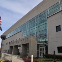 Photo of building with American flag, sign reads Justice Center