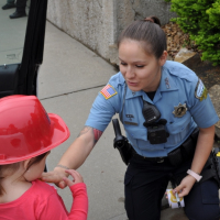 Police Officer gives a child a sticker.