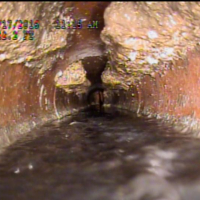 City sewer blockage - white spots along a pipe are a buildup as a result of fat or grease poured down the drain.