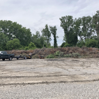 photo of truck next to large open brush pile at brush site