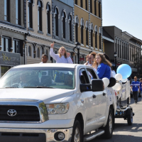 parade photo of girl riding in vehicle