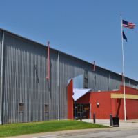 photo of large building with American and Kansas flags out front