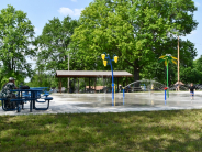 Sitting at picnic tables near splash pad