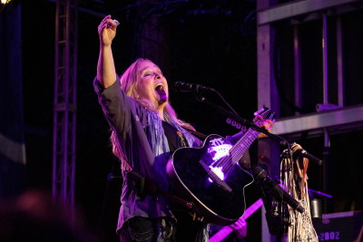 Photo of singer Melissa Etheridge on stage playing guitar